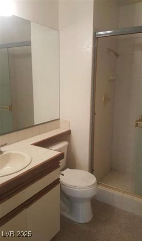 6974 Emerald Springs Ln, Las Vegas, NV 89113 - bathroom featuring toilet, vanity, and a stall shower
