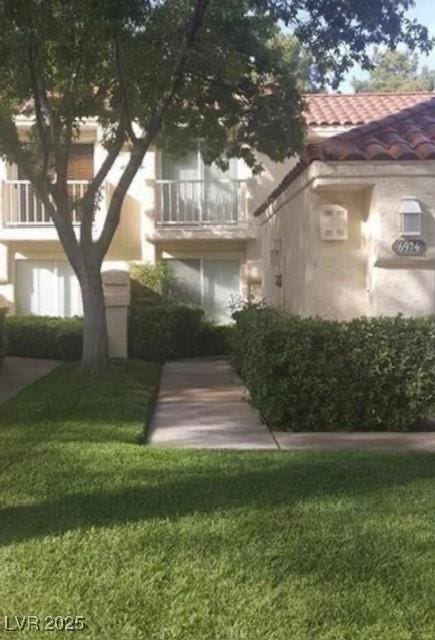 6974 Emerald Springs Ln, Las Vegas, NV 89113 - exterior space with a tile roof, a front lawn, and stucco siding