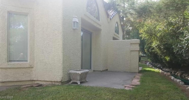 6974 Emerald Springs Ln, Las Vegas, NV 89113 - view of side of property featuring a patio area and stucco siding