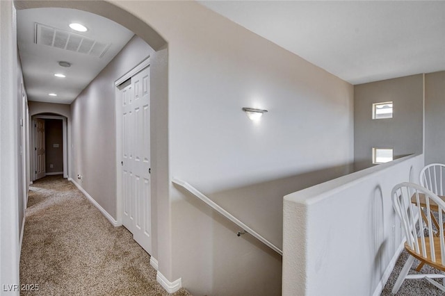 11036 Mount Hunter St, Las Vegas, NV 89179 - hall with arched walkways, carpet floors, and an upstairs landing