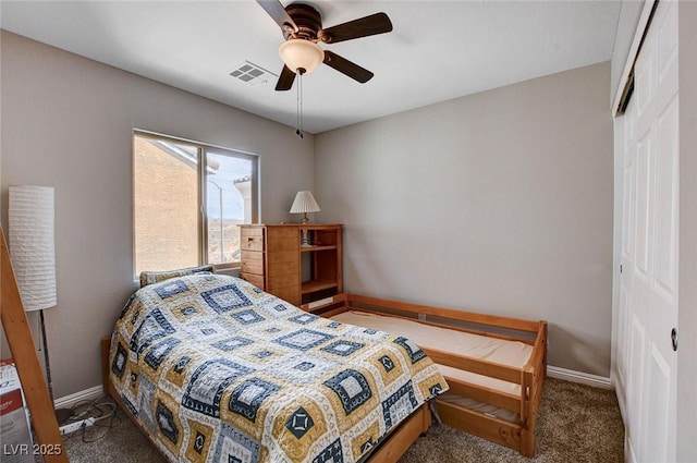 carpeted bedroom featuring a closet, baseboards, and ceiling fan