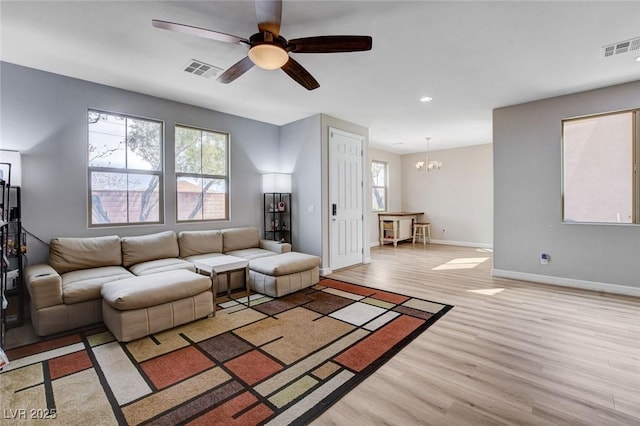11036 Mount Hunter St, Las Vegas, NV 89179 - living room featuring light wood finished floors, a chandelier, a ceiling fan, and recessed lighting