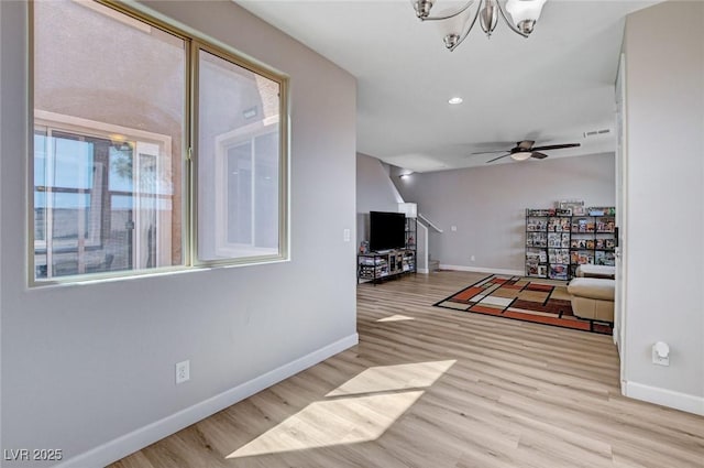 11036 Mount Hunter St, Las Vegas, NV 89179 - living room featuring wood finished floors, a chandelier, a ceiling fan, lofted ceiling, and recessed lighting
