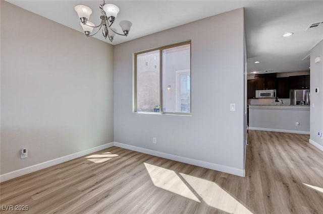 11036 Mount Hunter St, Las Vegas, NV 89179 - spare room featuring light wood-style flooring, a chandelier, and recessed lighting