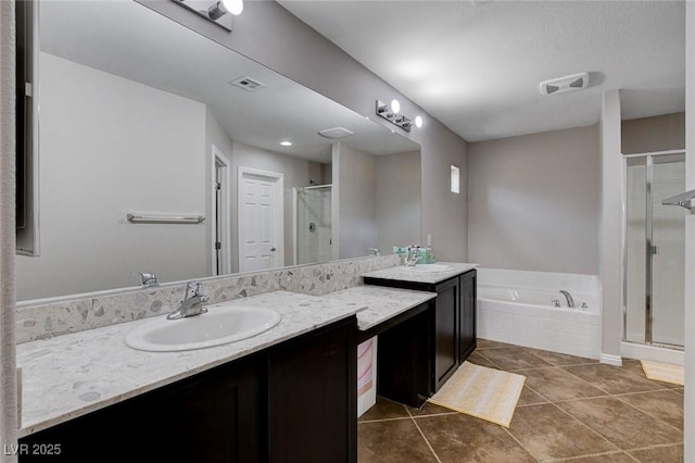 full bathroom featuring a shower stall, tile patterned floors, a garden tub, and vanity