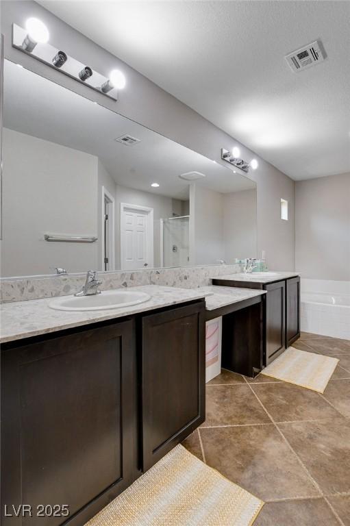 full bathroom with vanity, a shower with shower door, a garden tub, and tile patterned flooring