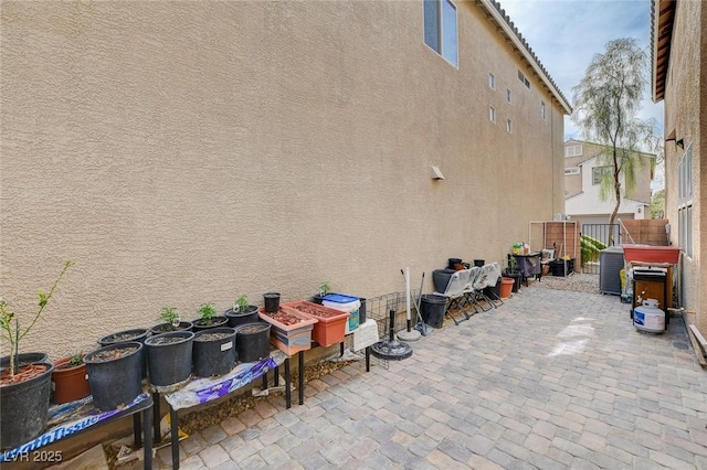 view of patio with fence and central air condition unit