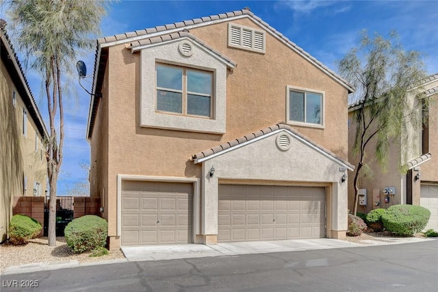 view of front of property featuring stucco siding, an attached garage, a tiled roof, and fence
