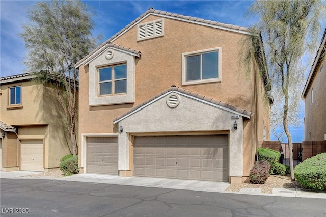 11036 Mount Hunter St, Las Vegas, NV 89179 - view of property with an attached garage, a tiled roof, and stucco siding