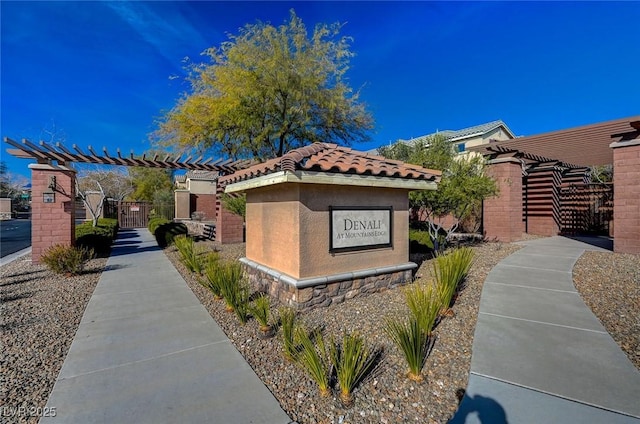 11036 Mount Hunter St, Las Vegas, NV 89179 - view of front of house with a pergola, a tiled roof, a gate, and stucco siding