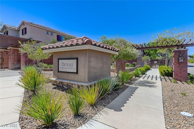 view of home's exterior featuring fence, stucco siding, and a tiled roof