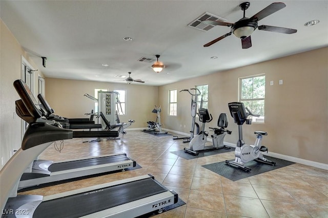 gym featuring ceiling fan, baseboards, and light tile patterned floors