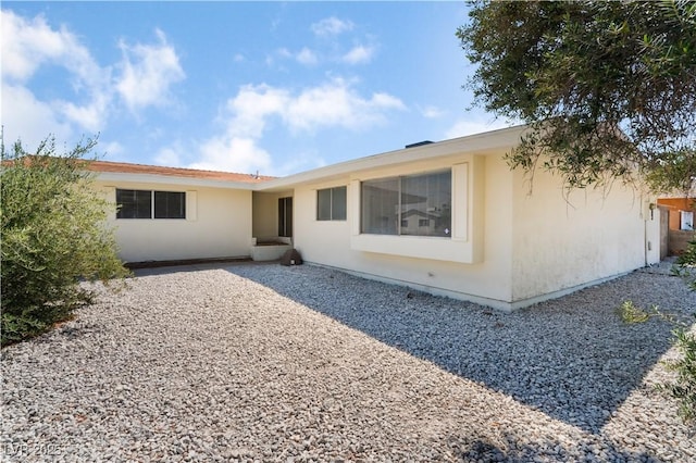 back of house featuring stucco siding