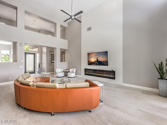 5 Clear Crossing Trl, Henderson, NV 89052 - living room featuring a high ceiling, ceiling fan, and a glass covered fireplace