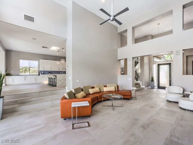 5 Clear Crossing Trl, Henderson, NV 89052 - living room with a high ceiling, a ceiling fan, and stairway