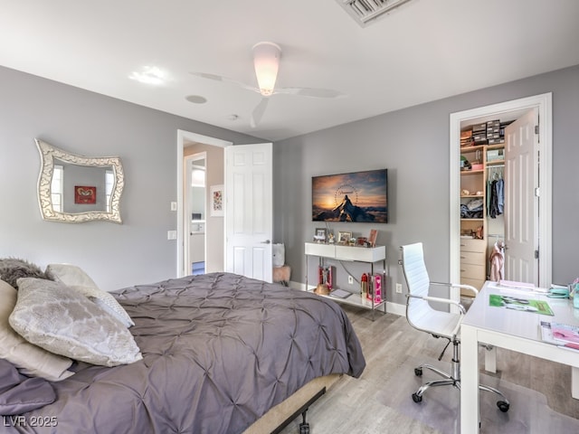 5 Clear Crossing Trl, Henderson, NV 89052 - bedroom featuring wood finished floors, a desk, a walk in closet, ceiling fan, and a closet