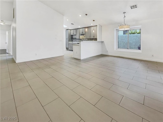 unfurnished living room with light tile patterned floors, visible vents, and recessed lighting