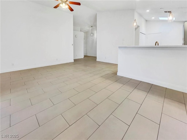 unfurnished living room with baseboards, tile patterned flooring, a ceiling fan, visible vents, and lofted ceiling