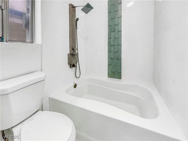 bathroom with washtub / shower combination and toilet