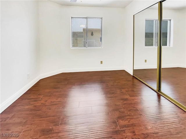 unfurnished room featuring wood finished floors and baseboards