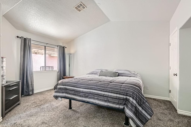 carpeted bedroom with visible vents, baseboards, vaulted ceiling, and a textured ceiling