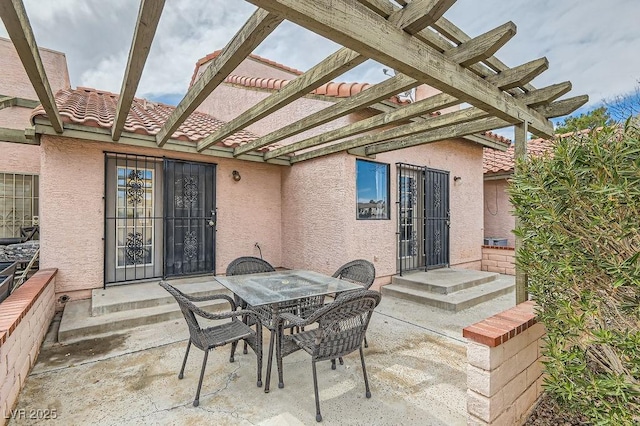 view of patio with a pergola and outdoor dining area