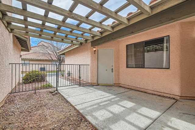 view of patio featuring a pergola and fence