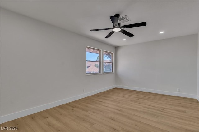 empty room with recessed lighting, visible vents, light wood-type flooring, and baseboards
