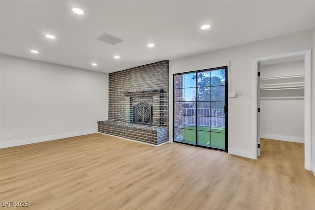 unfurnished living room with visible vents, baseboards, light wood finished floors, and recessed lighting