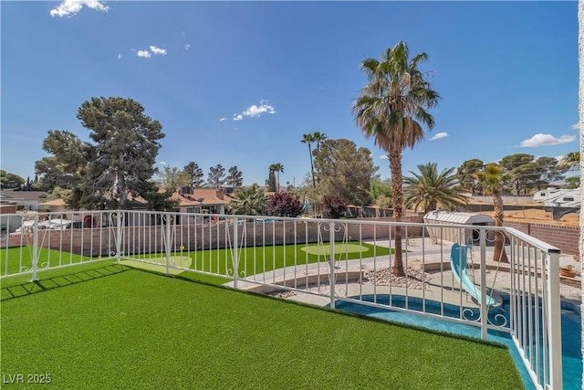 view of yard with a fenced in pool and fence