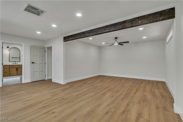 spare room with light wood-type flooring, baseboards, visible vents, and recessed lighting