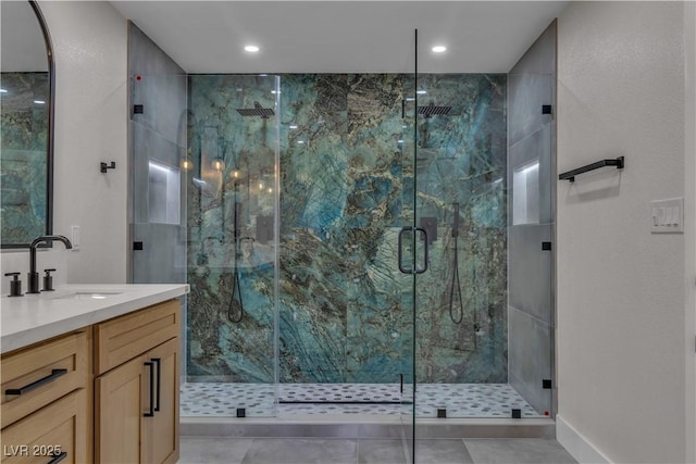 full bath with a marble finish shower, vanity, and recessed lighting