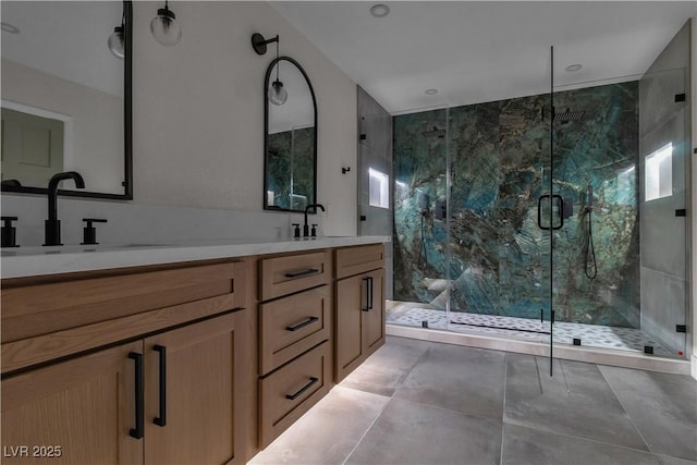 bathroom featuring double vanity, a marble finish shower, and a sink