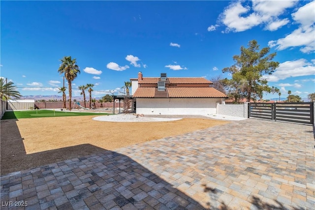 view of patio with fence and a gate