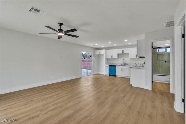 unfurnished living room with visible vents, baseboards, light wood finished floors, and a ceiling fan