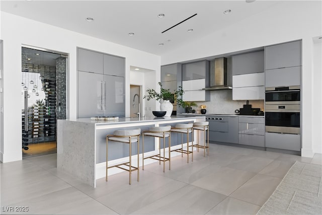 667 Palisade Rim Dr, Henderson, NV 89012 - kitchen with gray cabinets, wall chimney exhaust hood, modern cabinets, and recessed lighting