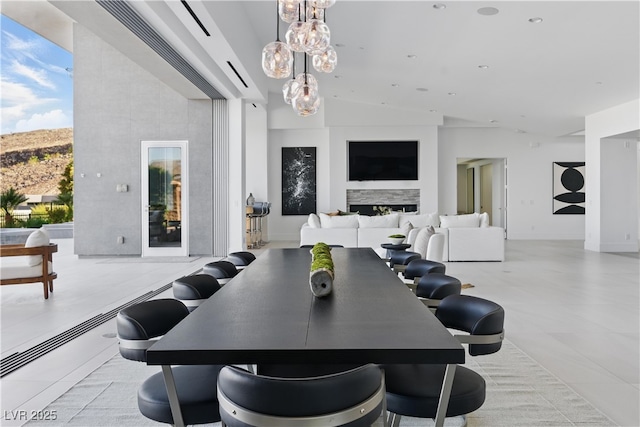 667 Palisade Rim Dr, Henderson, NV 89012 - dining area with a chandelier, high vaulted ceiling, and a fireplace