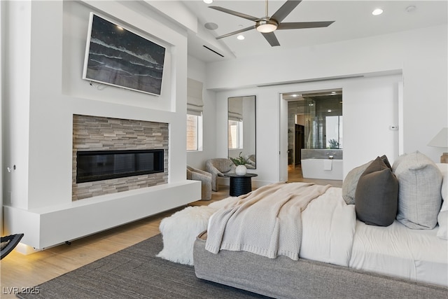 667 Palisade Rim Dr, Henderson, NV 89012 - bedroom featuring recessed lighting, wood finished floors, and a glass covered fireplace