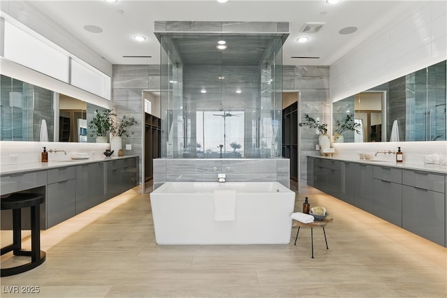 667 Palisade Rim Dr, Henderson, NV 89012 - bathroom with tile walls, a freestanding tub, and two vanities