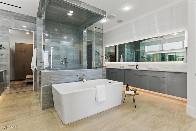 667 Palisade Rim Dr, Henderson, NV 89012 - bathroom with a freestanding bath, vanity, a stall shower, wood finished floors, and recessed lighting