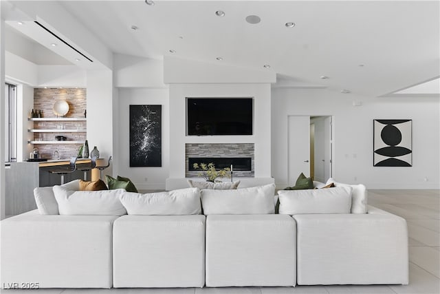 667 Palisade Rim Dr, Henderson, NV 89012 - living area featuring a glass covered fireplace, recessed lighting, light tile patterned flooring, and bar