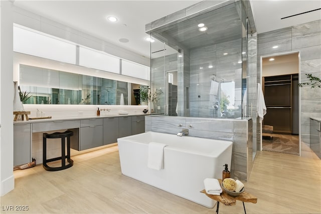 667 Palisade Rim Dr, Henderson, NV 89012 - bathroom featuring a freestanding bath, tile walls, vanity, a shower stall, and recessed lighting