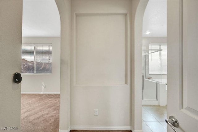 7216 Campolina Ct, Las Vegas, NV 89113 - corridor featuring tile patterned floors, baseboards, and arched walkways