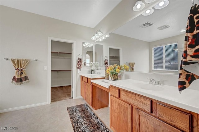7216 Campolina Ct, Las Vegas, NV 89113 - bathroom featuring tile patterned floors, visible vents, a spacious closet, and vanity