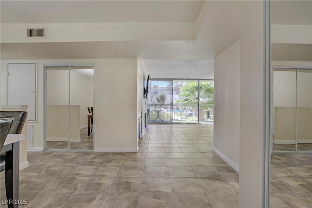 725 N Royal Crest Cir Unit 214, Las Vegas, NV 89169 - empty room with baseboards and light tile patterned flooring