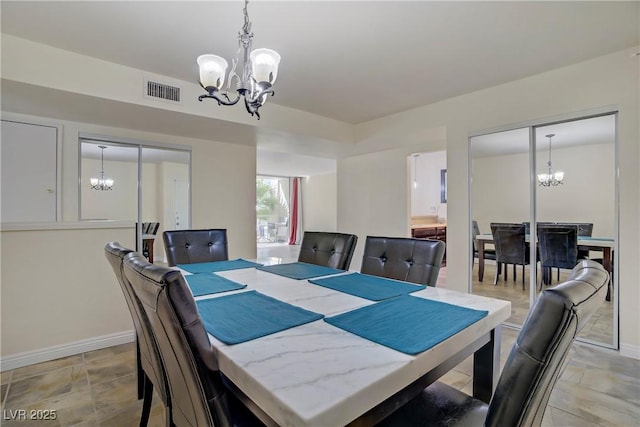 725 N Royal Crest Cir Unit 214, Las Vegas, NV 89169 - dining space with a chandelier and baseboards