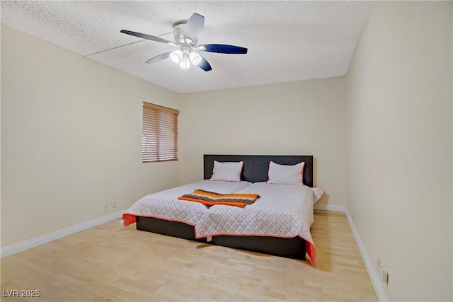 725 N Royal Crest Cir Unit 214, Las Vegas, NV 89169 - bedroom featuring a textured ceiling, wood finished floors, baseboards, and a ceiling fan