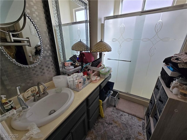 bathroom featuring a stall shower and vanity