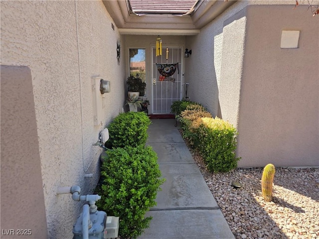 entrance to property with stucco siding