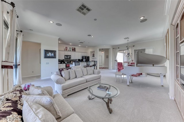 living room featuring light carpet, ornamental molding, visible vents, and recessed lighting
